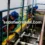 Teknisi melakukan cleaning IPAL dan penyedotan limbah cair menggunakan selang vakum profesional.